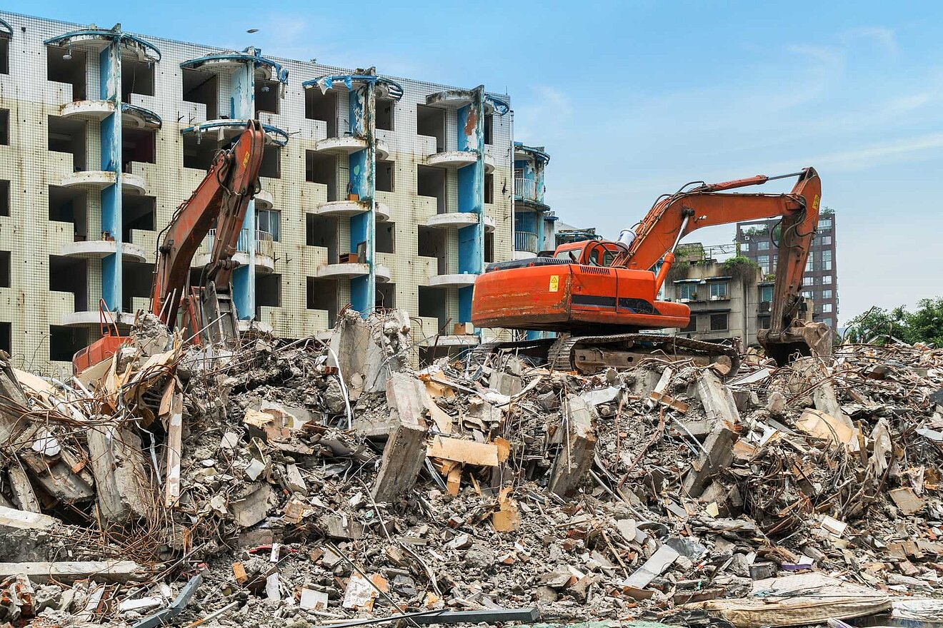 Gebäude im Abriss mit Bagger davor